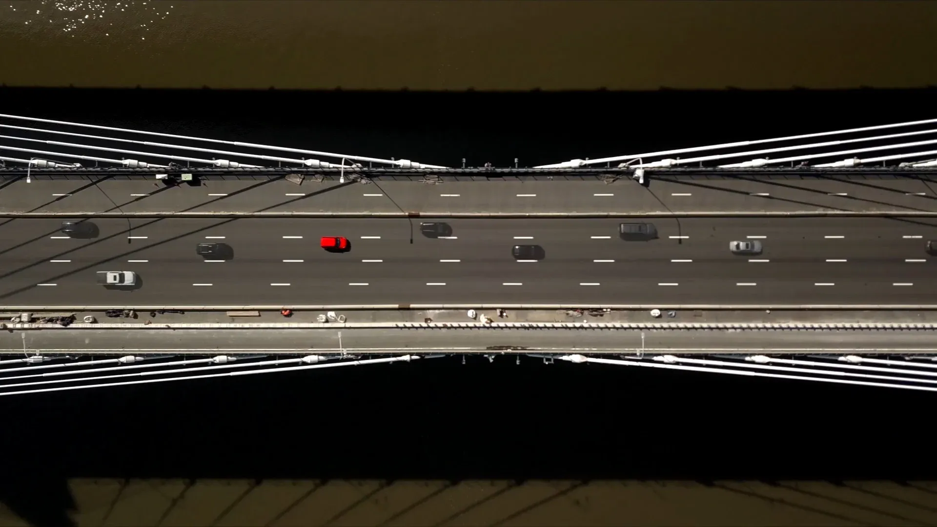 Aerial drone shot from Why Drive Electric — overhead view of the Tappan Zee Bridge with traffic crossing the Hudson.