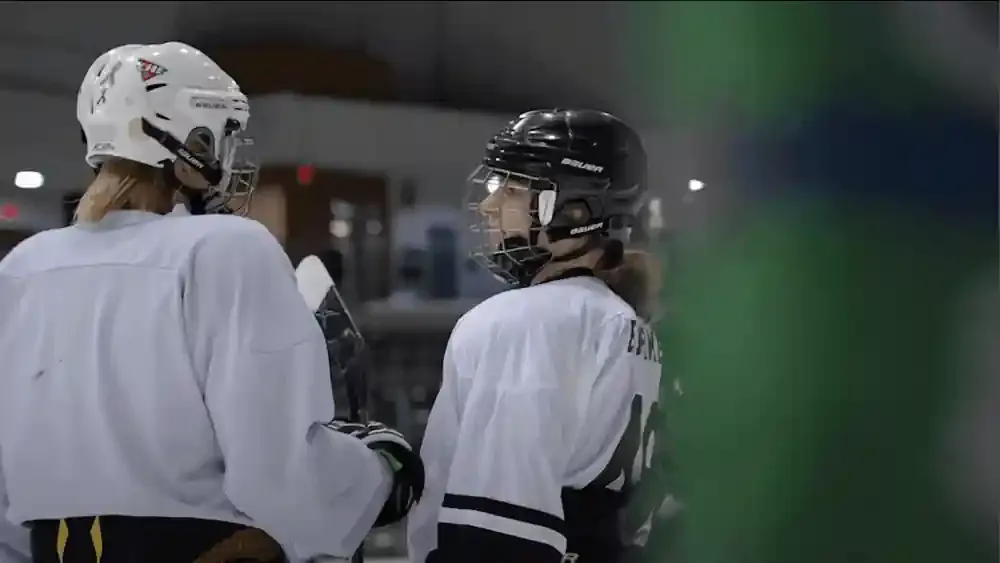 Film still from Brutal and Beautiful — the RIT Women's Club Hockey team on the ice.